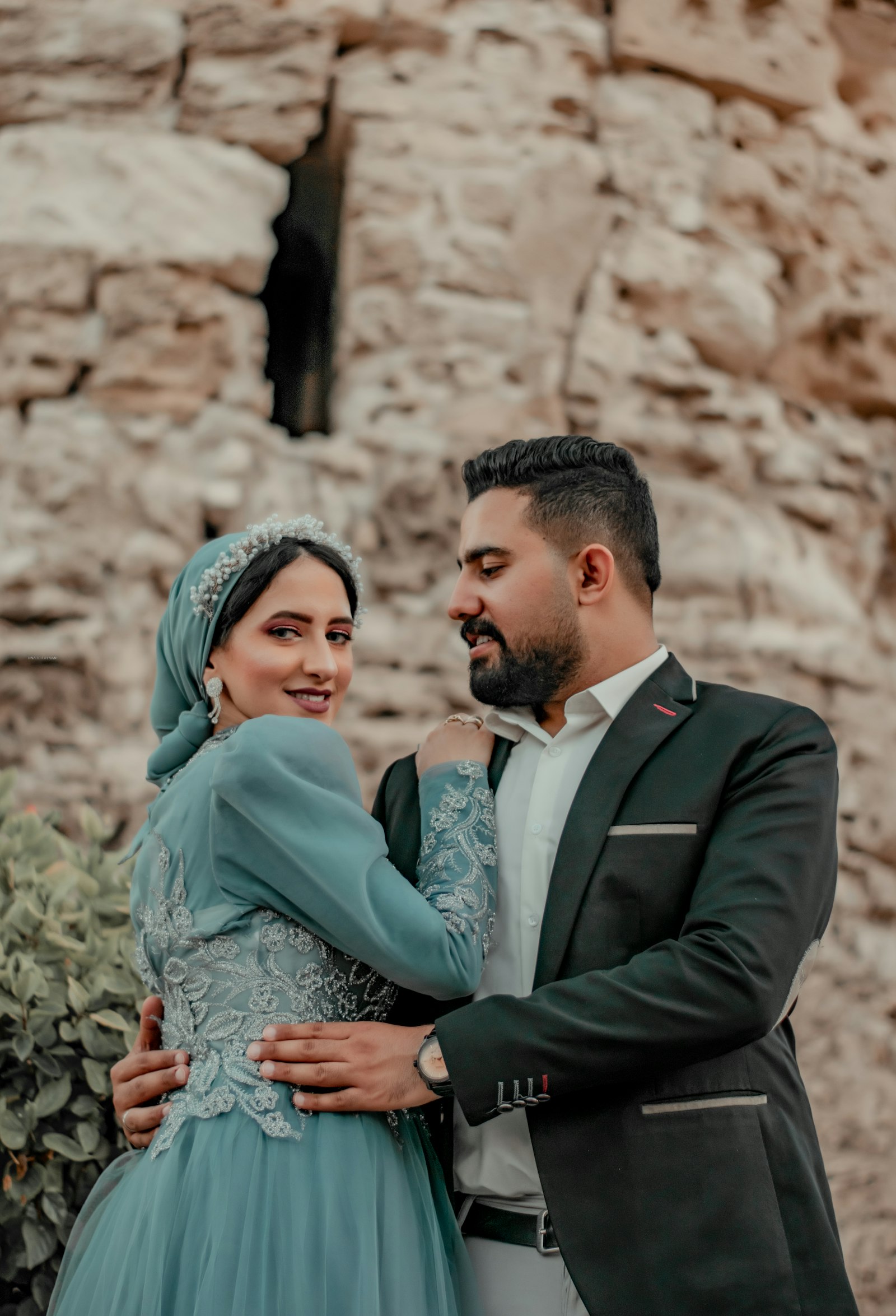 Muslim bride and groom standing together in wedding attire